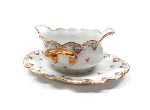 A Limoges porcelain part dinner service, 20th century, gilt and foliate decorated, comprising; twenty four dinner plates, 24.5cm diameter, a set of th