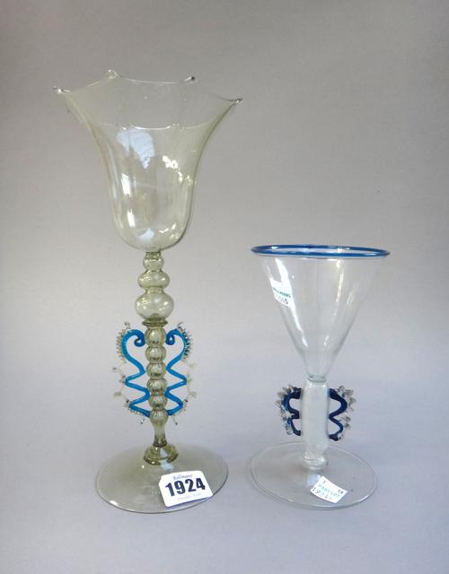 Two Venetian glass winged goblets, late 19th century, one green tint with tulip shaped bowl multi-knopped stem and blue trailed `wings', 24.5cm. high,