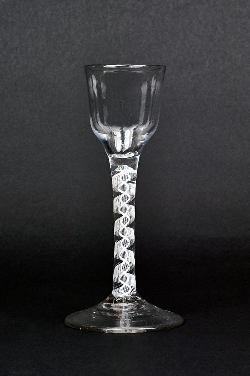 An opaque twist wine glass,circa 1760, the ogee bowl raised on a double series opaque twist stem and plain foot, 15.5cm. high.  Illustrated