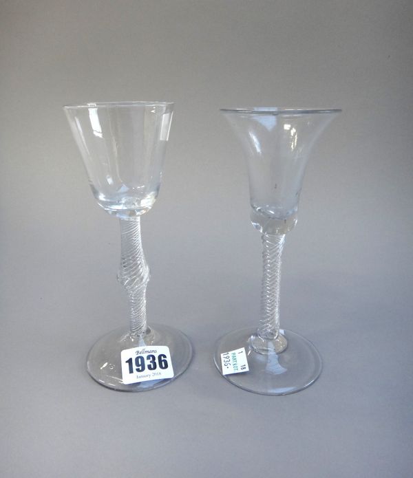 Two airtwist wine glasses, mid 18th century, the first with rounded funnel bowl and knopped stem, the second with trumpet bowl, 16.5cm. and 16cm.