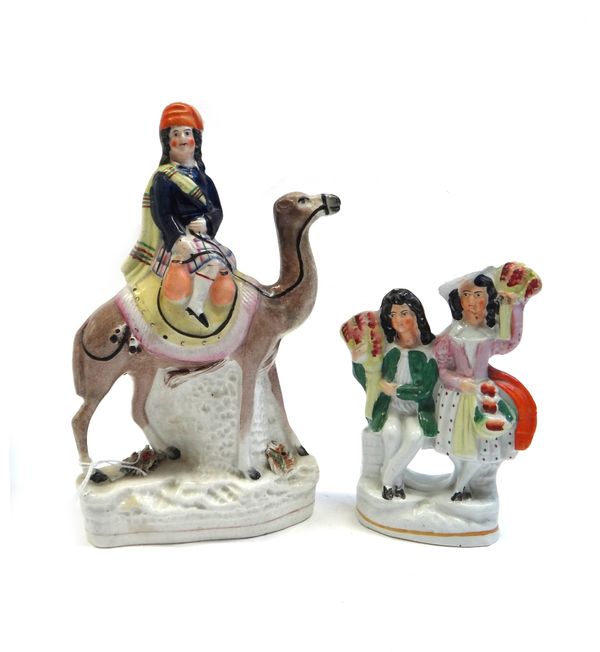 A Staffordshire pottery group, 1860's, probably portraying Sir Richard Francis Burton, modelled seated on the back of a camel, 24cm. high; also a Staf