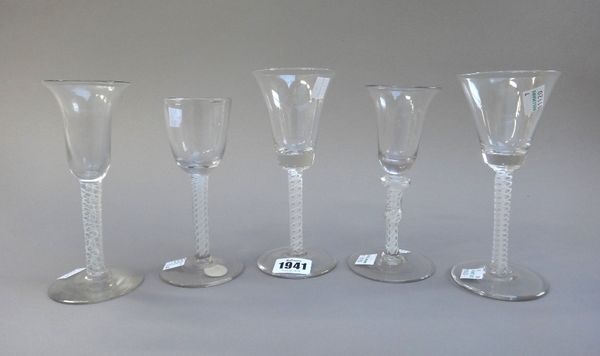 Two opaque twist wine glasses, 20th century, each with flared bowl, raised on a double series opaque twist stem and plain foot; together with three ot