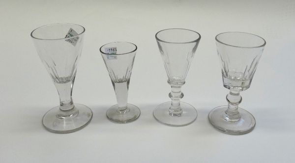 A group of twenty five small drinking glasses, mostly early 19th century, of various form and size; also a glass custard cup; a glass Jubilee plate, 1