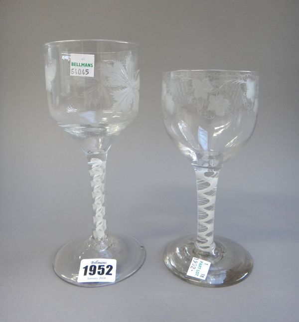 An opaque twist glass goblet, circa 1765, the ogee bowl engraved with fruiting vine and an insect, raised on a double series opaque twist stem and pla