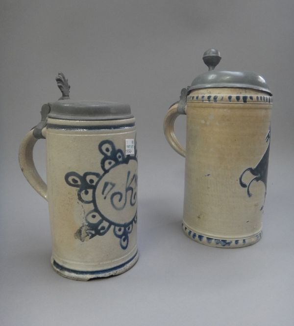 Two Westerwald stoneware pewter-mounted cylindrical tankards, 18th century, the taller incised and washed in blue with a rearing horse, the other pain