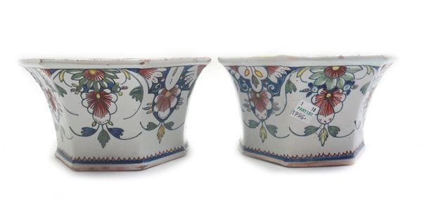 A pair of Rouen faience bough pots, 18th century, each top pierced with holes, the panelled sides painted with flowers, 16.5cm. wide.