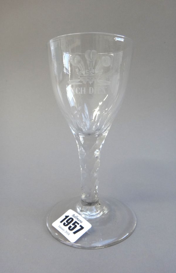 A facet stemmed wine glass, late 18th century, the rounded funnel bowl engraved with the Prince of Wales feather and the motto `Ich Dien', raised on a