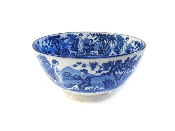 A Dawson blue and white printed earthenware bowl, circa 1820, printed with a seated boy offering up a bird's nest to a girl standing beside with dog,