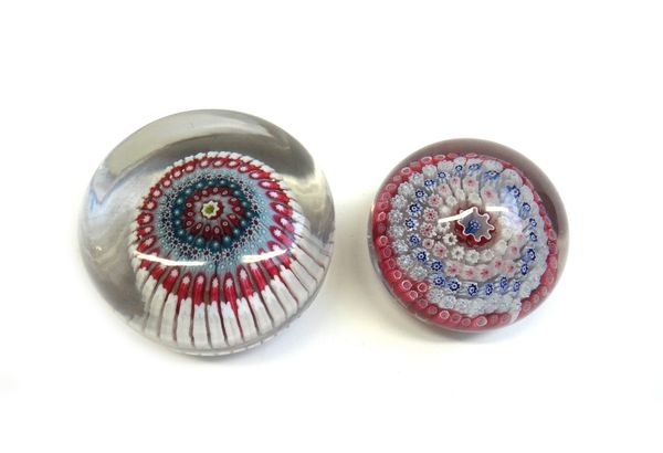 An English concentric millefiori paperweight, 19th century, set with five rows of canes around a central pastrymould cane, pontil mark to base, (a.f),