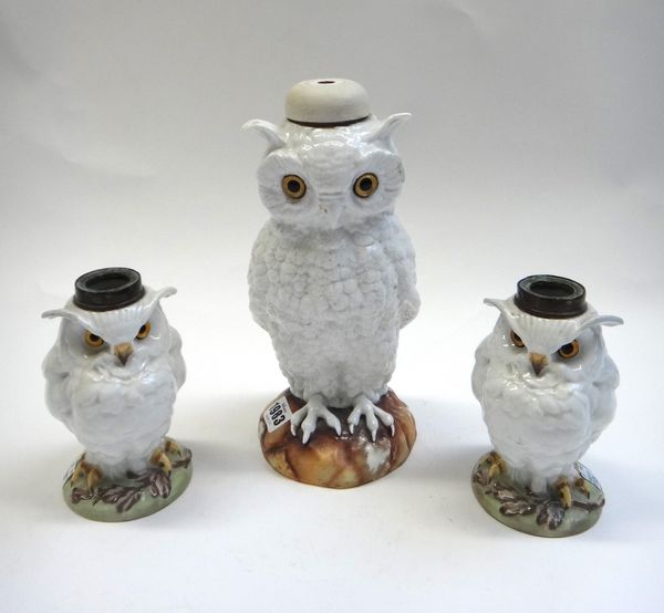 A Continental porcelain 'Owl' table lamp, circa. 1900, modelled atop a naturalistic circular base (27cm high) and a smaller similar pair of porcelain