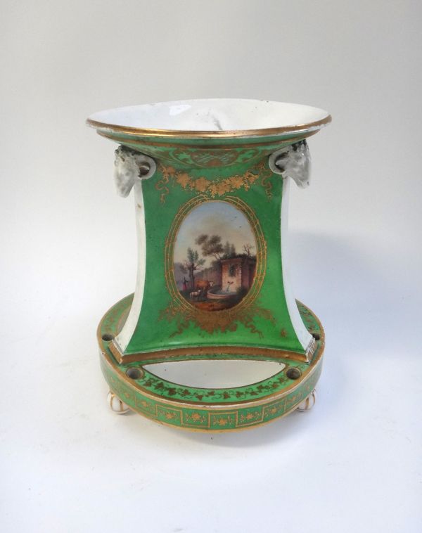 A Sevres style desk stand, of circular stepped form, hand painted with riverscapes against a gilt green ground, 17.5cm high, a Paris yellow and gilt c