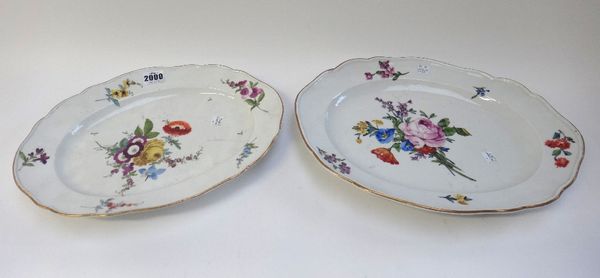 A Meissen porcelain shaped oval platter, circa 1770, hand painted with flowers, 34.8cm wide, and another larger slightly later Meissen oval platter wi