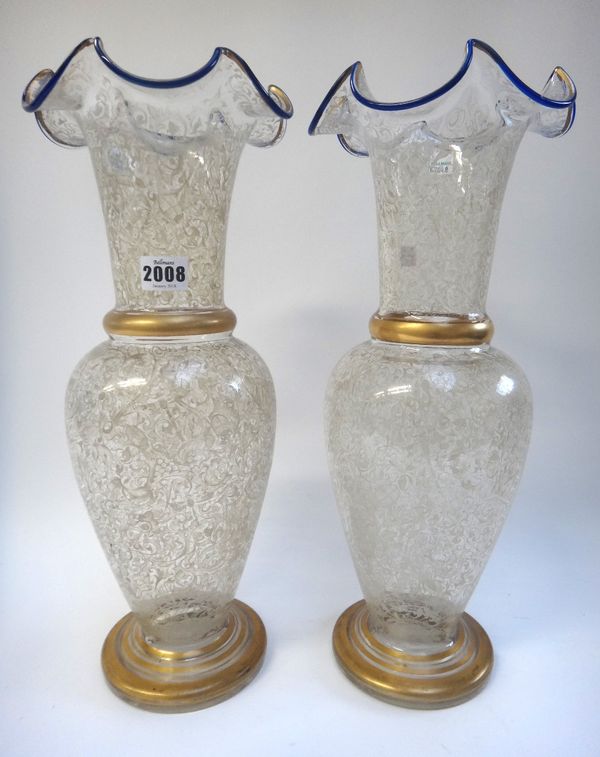 A pair of Lobmeyer style enamel glass vases, each with a blue line frilled rim and gilt banded decoration against a baluster body, 44.5cm high, (2).