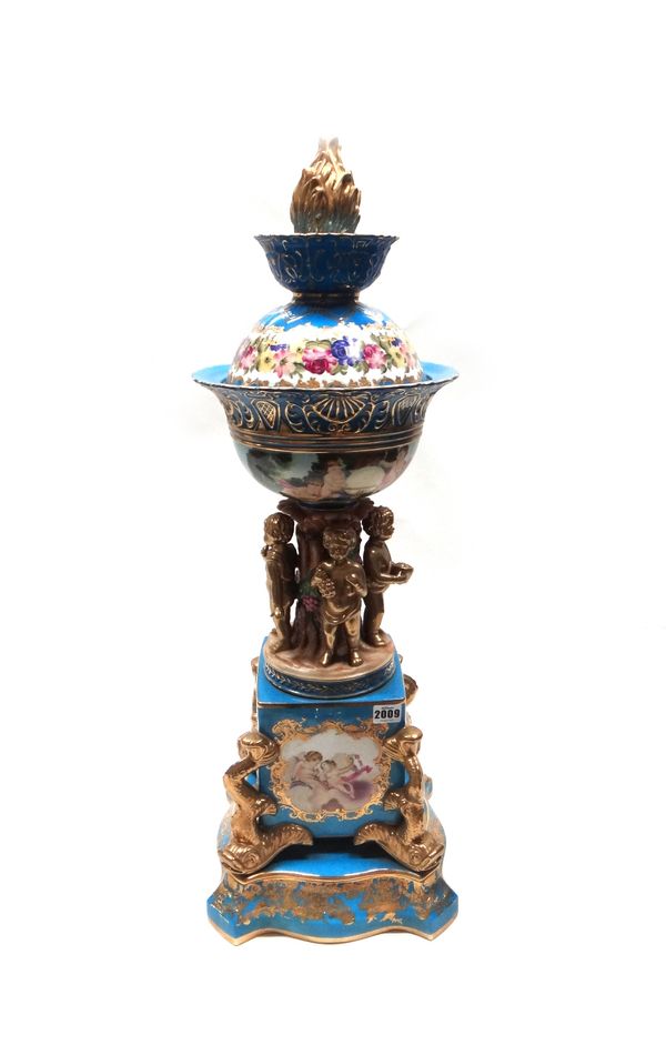 A Sevres style blue ground bowl and cover on stand, 20th century, the circular domed cover with gilt flame finial over a bowl supported by four gilt p