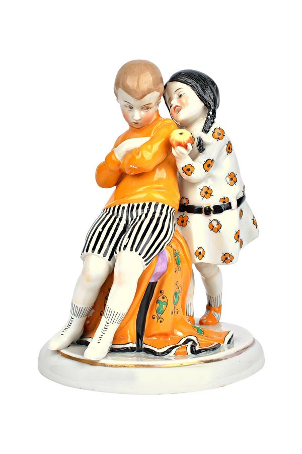 A Goebel Art Deco porcelain figure group, circa 1920, modelled as two young children with an apple, signed 'LUND', blue painted and incised marks, 22c