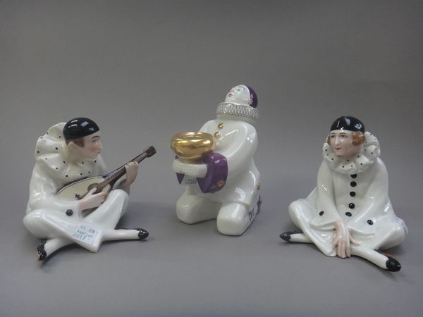 A French porcelain 'Pierrot' perfume light of Art Deco form, 15.5cm high, and a pair of Continental porcelain 'Pierrot' figures, one playing a mandoli