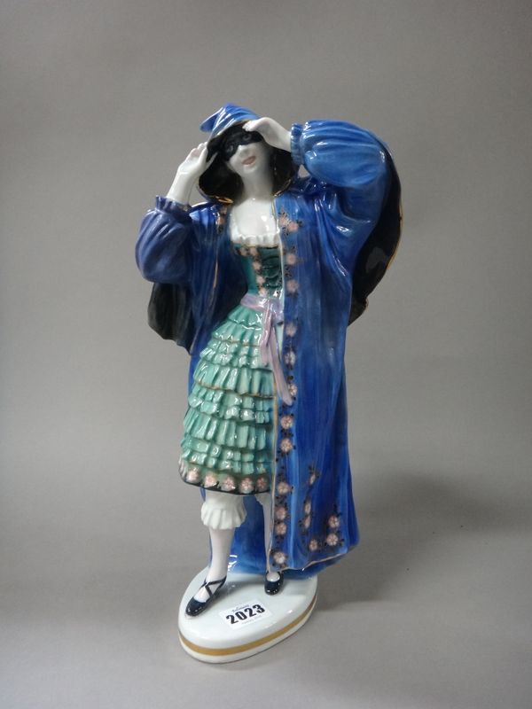 A Volkstedt Karl Ens porcelain figure, early 20th century, modelled as a lady in a long blue cape, with green dress and masquerade mask, printed and p