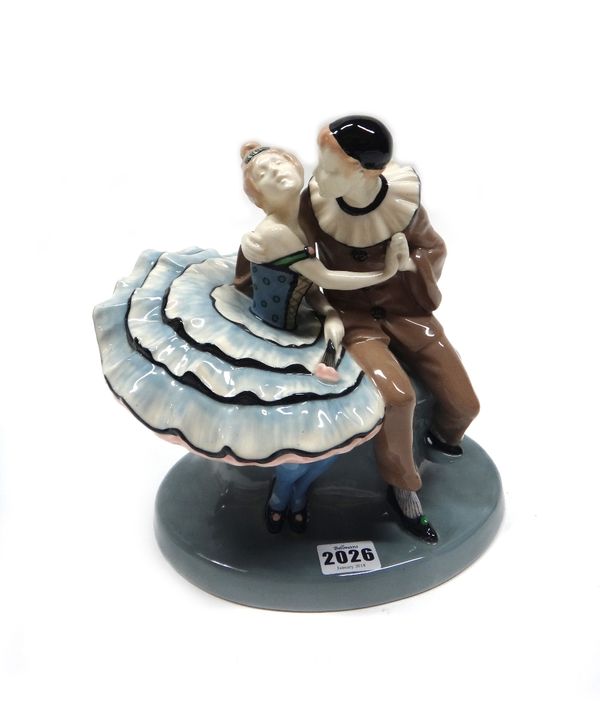 A German Art Deco pottery figure group by Maxim Berlin, circa 1930, modelled as a Pierrot and female dancer in a romantic embrace, incised and painted