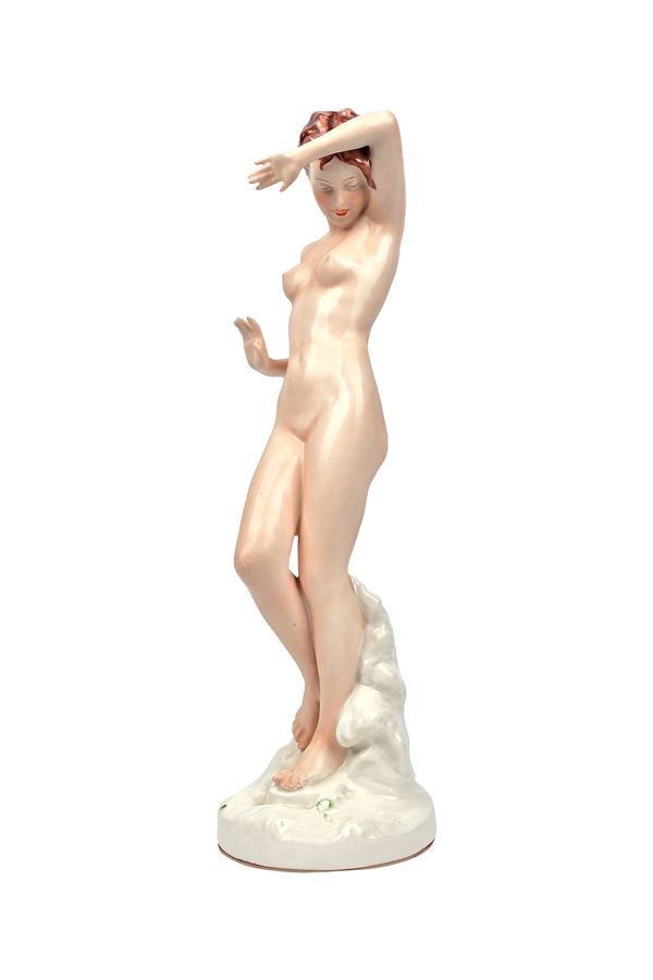 A Royal Dux figure of a female nude, circa 1935, modelled atop a naturalistic circular base, pink triangle and impressed No 723, 38cm high.  Illustrat