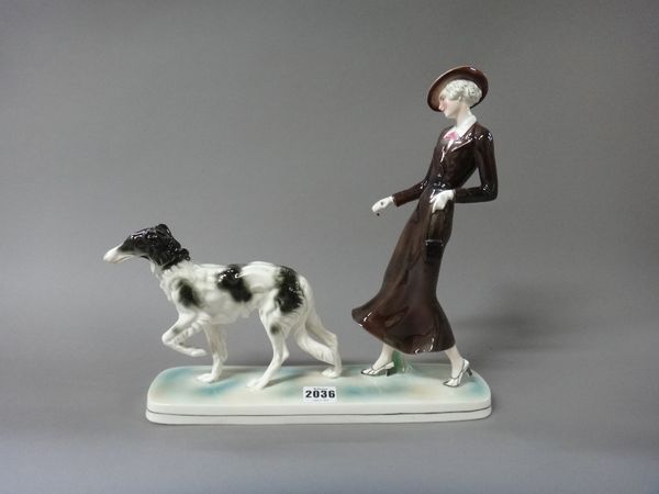 A Katzhutte Art Deco figure group, circa 1930, modelled as a lady leading a Borzoi hound, printed marks, 33cm wide.