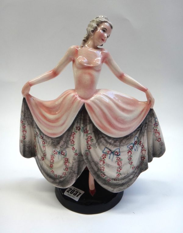 A Goldscheider figure of a dancer, circa 1930, modelled in a pink floral print dress, model no.8301, impressed and printed marks, 31cm high.