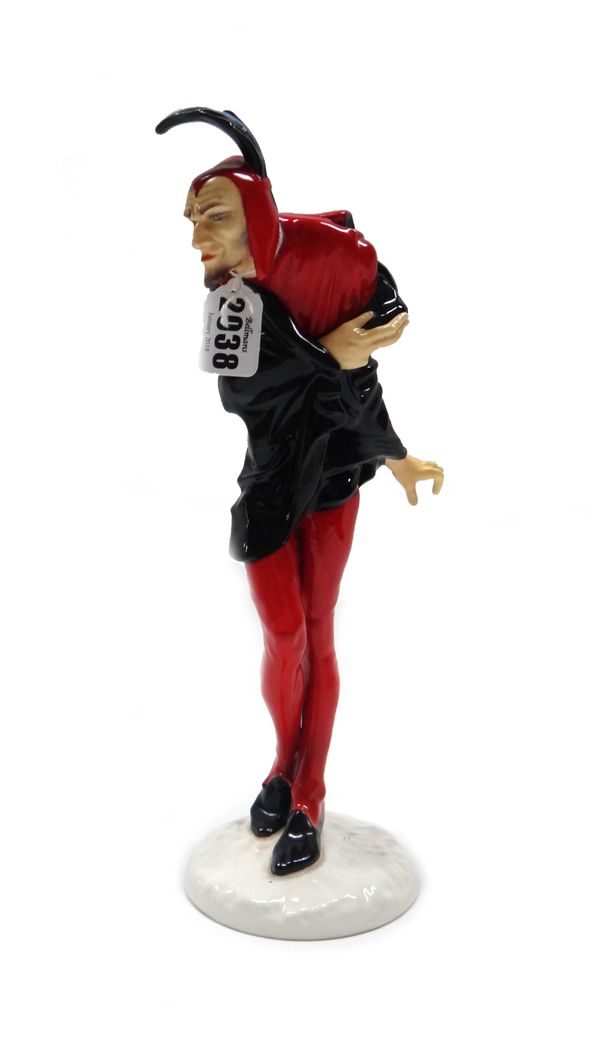 A Hutschenreuther 'Jester' figure, circa 1930, modelled in red and black taking a bow, atop a circular base, with paper label and printed marks, (a.f)