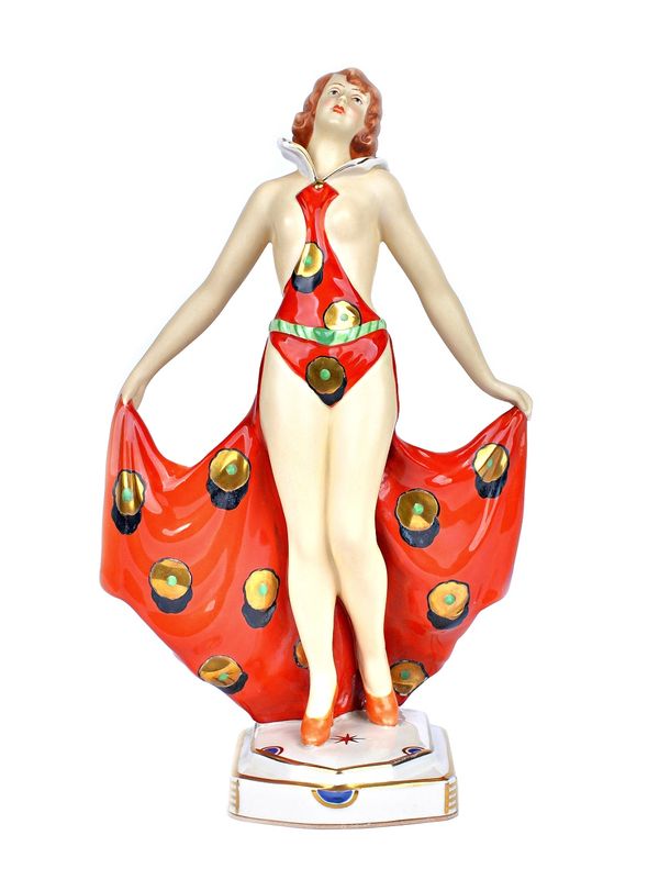 A Royal Dux Art Deco semi-nude dancing girl, by Elly Strobach, circa 1925, modelled in a gilt floral red dress, with pink triangle, impressed and prin