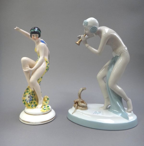 A Katzhutte Art Deco female dancer, circa 1930, modelled in a yellow floral dress, model no.6609, 21cm high, and a Royal Dux 'Snake Charmer', with pin