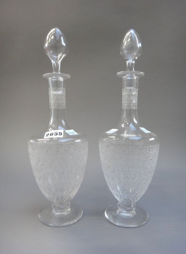 A pair of Baccarat glass decanters and stoppers, late 20th century, each with engraved neck and body over a circular foot, etched mark to base, 34.5cm