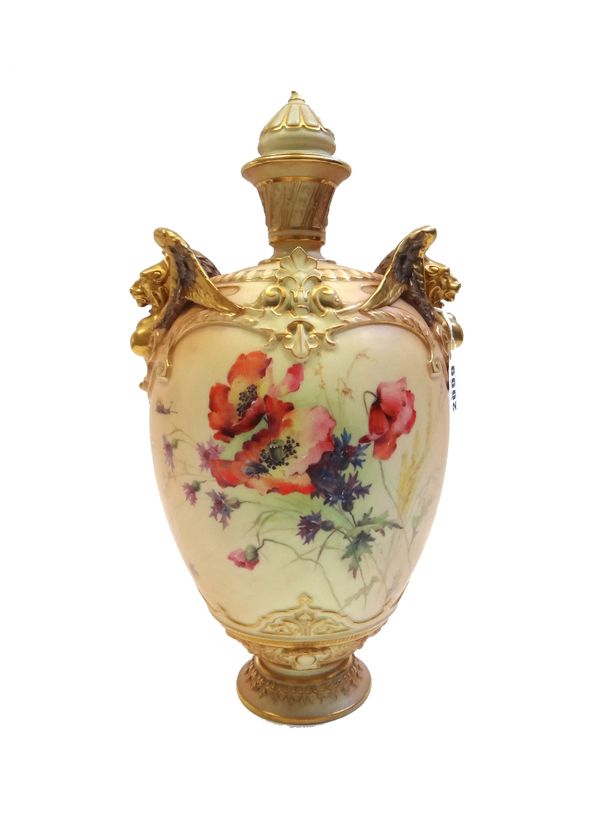 A Royal Worcester blush ivory vase and cover, circa 1900, with twin gilt anthropomorphic mask handles against an ovoid body, hand painted with flowers