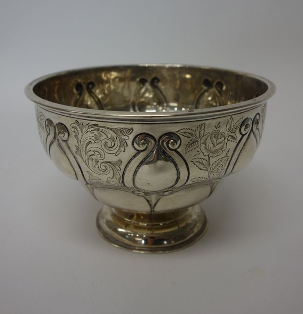 A silver bowl of circular form, engraved with floral sprays alternating with feathered scrolls, raised on a circular foot, London 1904, diameter 17cm.