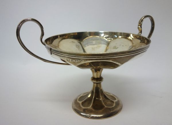 A silver twin handled tazza dish, with panelled decoration, raised on a swept circular foot, Birmingham probably 1910, weight 351 gms.