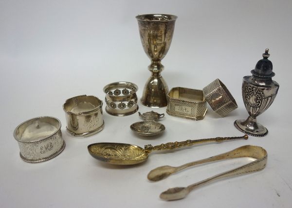 Silver, comprising; five napkin rings, a model of The Coronation Anointing Spoon, London 1910, a pair of sugar tongs and a double ended egg cup, combi