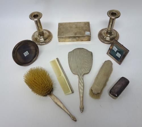 Silver and silver mounted wares, comprising; a pair of candlesticks, each on a circular base, Birmingham 1905, height 13cm (loaded), a rectangular tab
