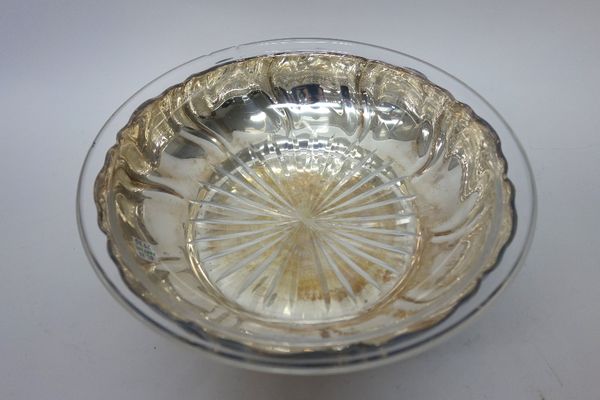 A German bowl, of shaped circular form, with shallow spiral fluted decoration, detailed 835, weight 353 gms, with a glass liner, having a star cut bas