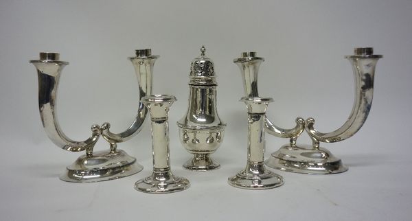 Silver mounted wares, comprising; a baluster shaped sugar caster (loaded) Birmingham 1938 and a pair of candlesticks, each on a circular base (loaded)