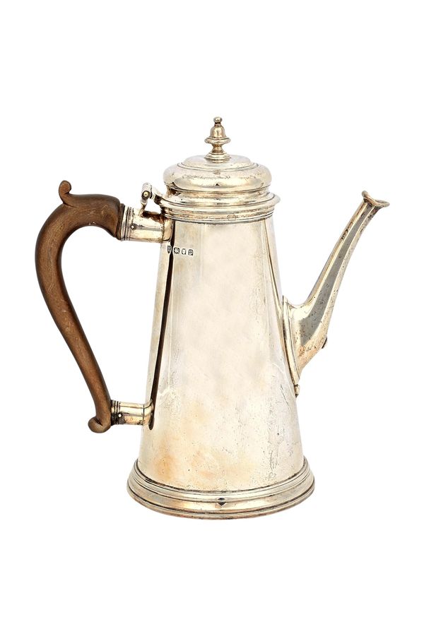 A silver coffee pot, in a tapering cylindrical design, on a circular foot, in the 18th century taste, fitted with a wooden handle, London 1930, gross