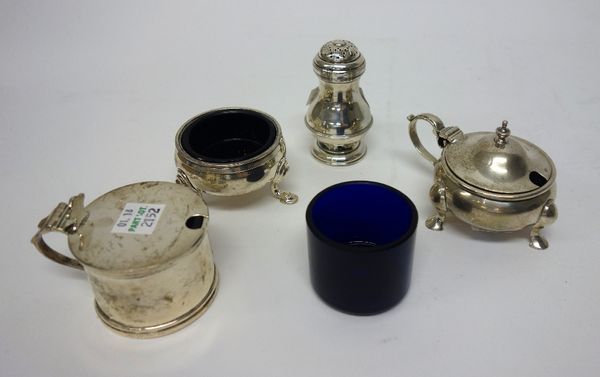 Silver, comprising; a three piece condiment set, comprising; a mustard pot, a salt and a pepperette, with three blue glass liners, London 1938 and ano