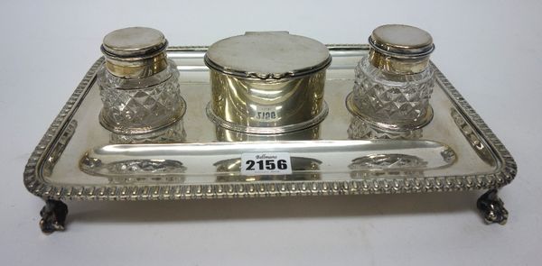 A late Victorian silver rectangular twin bottle inkstand, the centre with an oval hinge lidded box compartment, with two recesses for pens, with beade