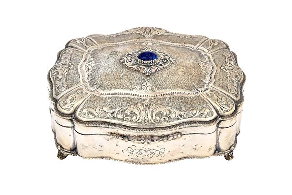 A European shaped rectangular hinge lidded box, gilt within, the hinged lid mounted with a paste imitating lapis lazuli, otherwise decorated with scro