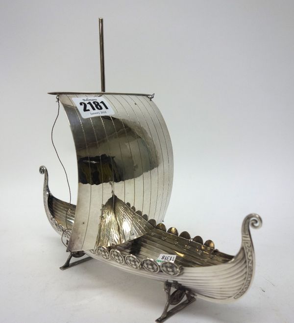 A Scandinavian model of a sailing ship, in the Viking style, modelled with rows of circular shields to the sides, fitted with a single sail and with a