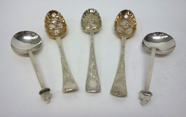 Three Irish silver berry fruit spoons, having differing decoration of a later date, Dublin 1766, 1771 and 1773 and a two similar spoons, each with a f