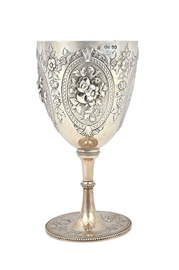 A Victorian silver goblet, decorated with three oval floral panels and with further floral sprays, presentation inscribed, raised on a beaded circular