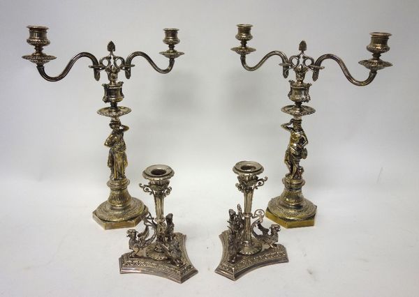 A pair of plated twin light table candelabra, the differing stems formed as classical figures, raised on hexagonal bases, height 39cm and a pair of pl