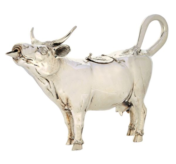 A silver cow creamer, modelled as a standing cow, the oval hinged lid engraved with an insect, detailed Sterling, import mark London 1958, weight 268