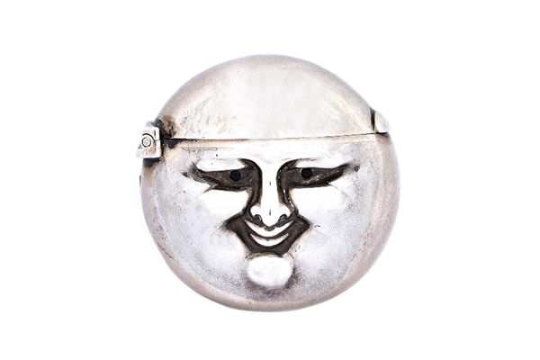 A late Victorian silver vesta case, of circular form, designed as the face of The Man in The Moon, with cabochon black gem set eyes, by Sampson Mordan