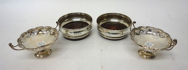 A pair of silver mounted bottle coasters, of circular form, having differing wooden bases, Birmingham 1972 and a pair of silver twin handled bonbon di