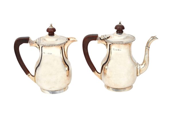 A silver two piece cafe au lait set, comprising; a coffee pot and a hot milk jug, each piece of baluster form, below a gadrooned rim, Birmingham 1925