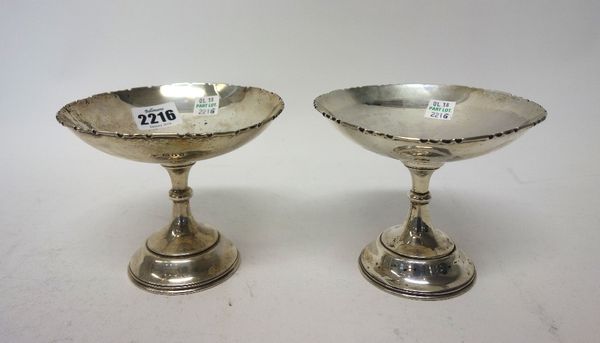 Two similar silver tazzae, both of circular dish shaped form, with a shaped border, presentation engraved to the centre and raised on a circular foot,