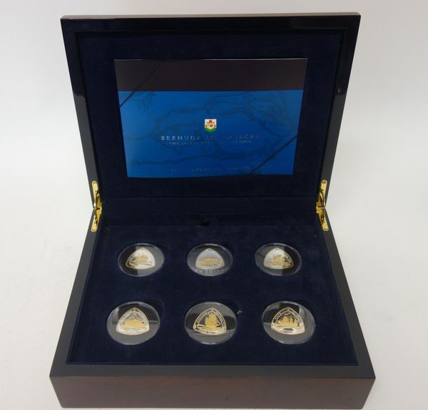 A set of twelve silver and gilt curved triangular commemorative coins, 2007, commemorating Bermuda shipwrecks, with a Royal Mint Certificate of Authen